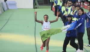 Bahrain’s Shitaye Eshete Habte crossing the finish line, arms lifted in triumph, during the 2026 Hong Kong Marathon