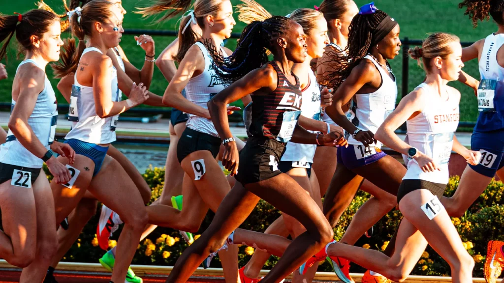 Edna Chelulei running with competitors in the women’s indoor 3,000m at Boston University, maintaining pace in the lead pack.