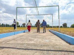 Barnaba Korir, Ibrahim Hussein, and technical officials reviewing the mist zone at Lobo Village cross-country course for the 2026 Sirikwa Classic.